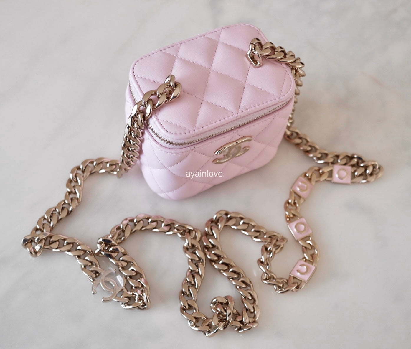Pale pink leather and gold chain purse strap